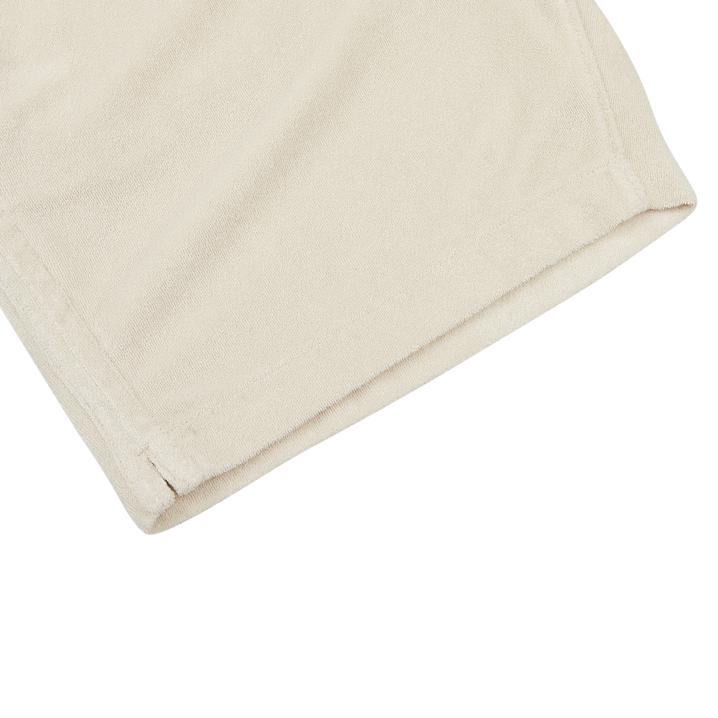 A close-up view of a beige-colored, folded pair of Cream Beige Cotton Towelling Shorts by Paige, made from a towelling cotton blend, on a white surface.