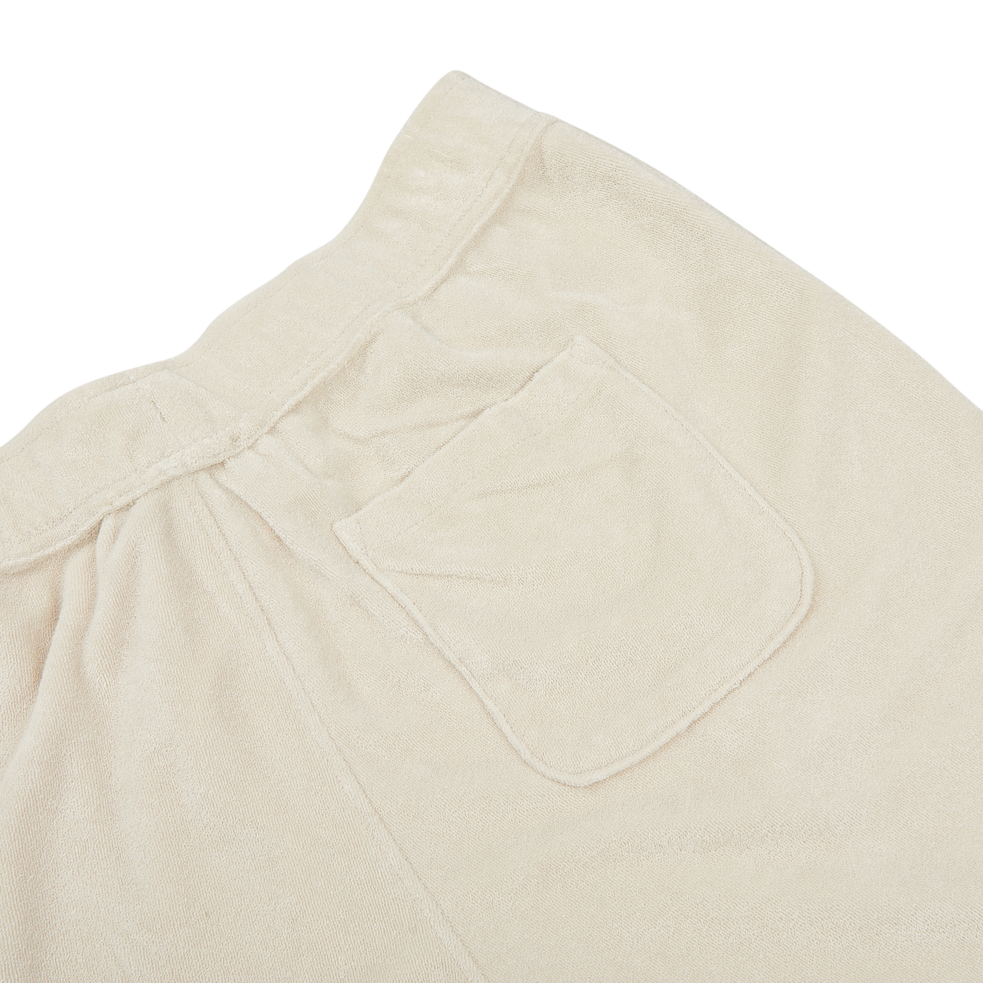 Close-up of the back pocket and waistband area of a pair of Paige Cream Beige Cotton Towelling Shorts, showing the fabric texture, stitching details, and a comfortable drawstring waist.
