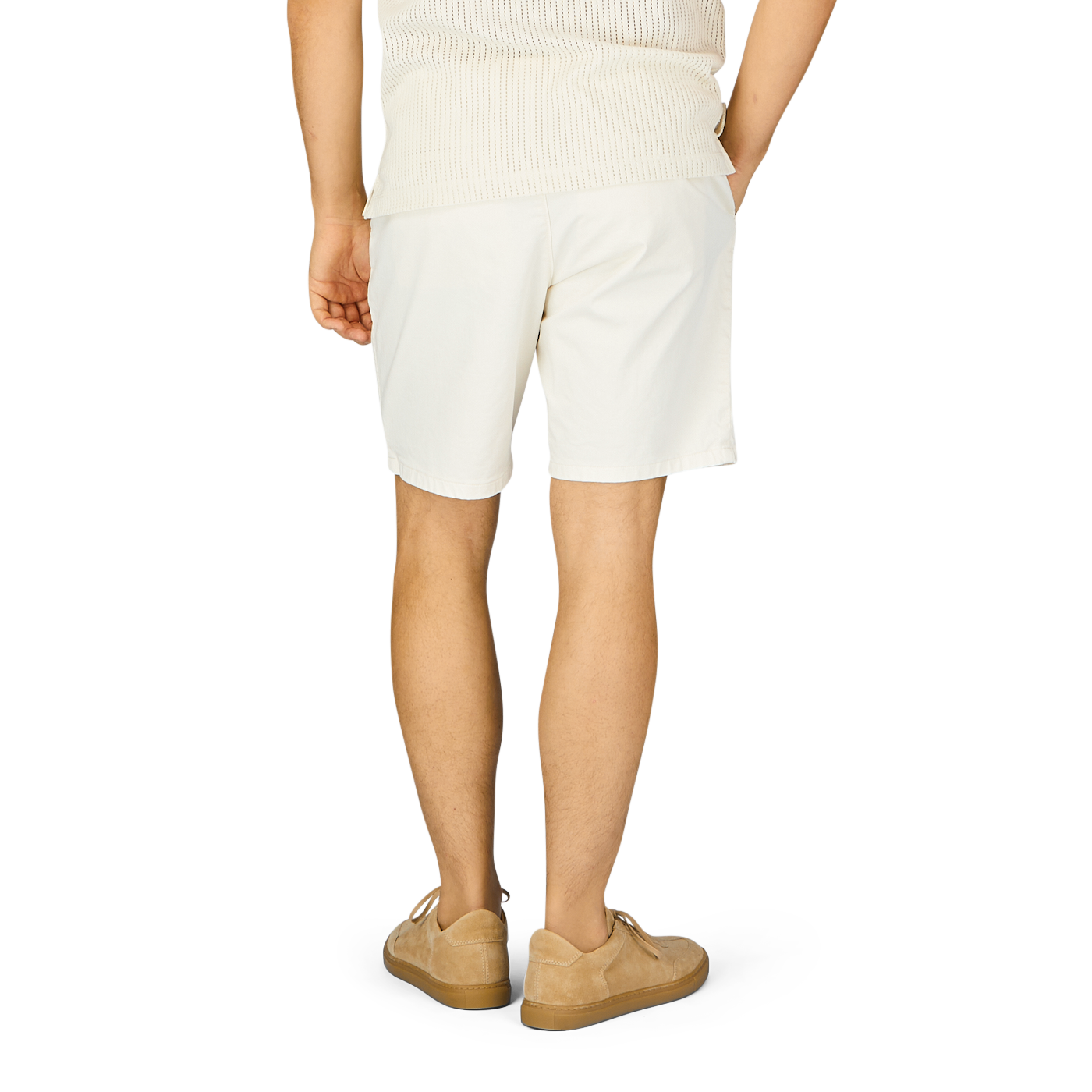 The back view of a man wearing Ecru Cotton Blend Philips Shorts by Paige and a tan shirt.