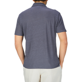 The man is wearing a breathable Grey Blue Linen Capri Collar polo shirt by Paige.