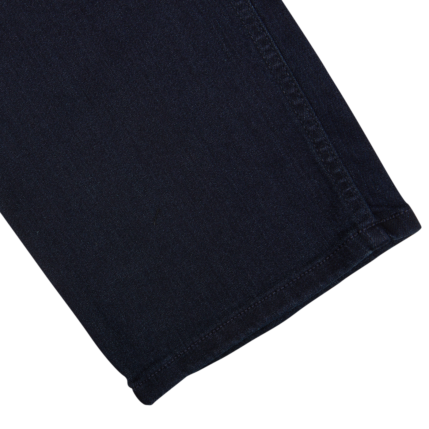 A close-up of a Paige Inkwell Blue Cotton Transcend Normandie Jeans with a visible seam and hem,possibly a part of regular fit jeans.