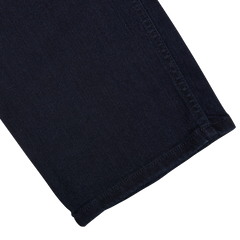 A close-up of a Paige Inkwell Blue Cotton Transcend Normandie Jeans with a visible seam and hem,possibly a part of regular fit jeans.