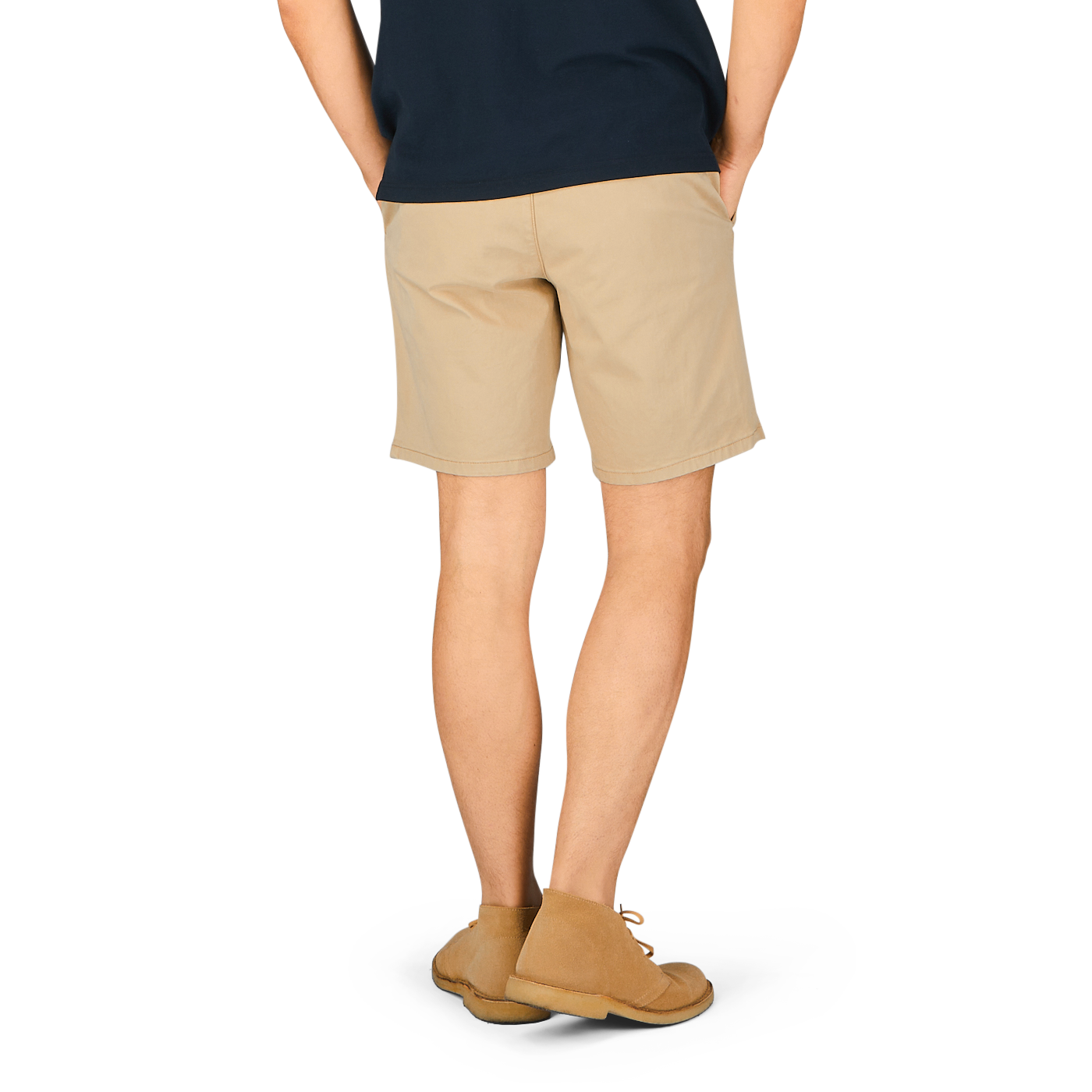 A person standing, wearing khaki beige Paige Phillips shorts and tan shoes, with a dark-colored top, viewed from the waist down.