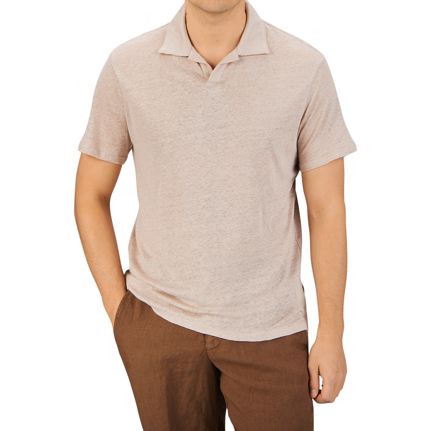 Man in a Paige light pink linen Capri collar polo shirt and brown pants standing against a gray background.