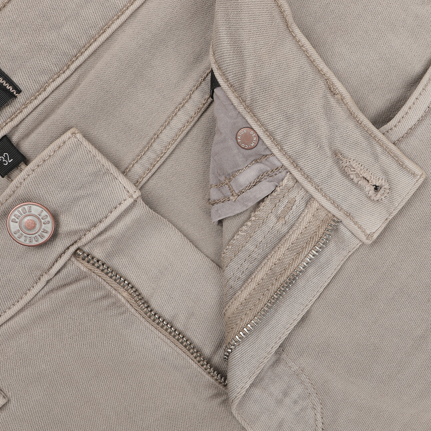 Close-up of Moroccan Clay Cotton Transcend Federal Slim Jeans by Paige, showcasing a partially unzipped fly, button closure, and visible stitching details, crafted from Transcend fabric for exceptional comfort and fit.