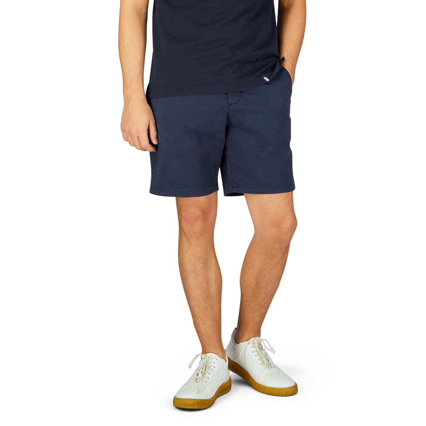 Man wearing Navy Blue Cotton Blend Phillips Shorts by Paige and white sneakers with yellow soles against a neutral background.