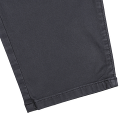 Close-up of the bottom hem of a pair of Navy Blue Danford Cotton Chinos by Paige, highlighting their cotton stretch for a comfortable fit, set against a light background.