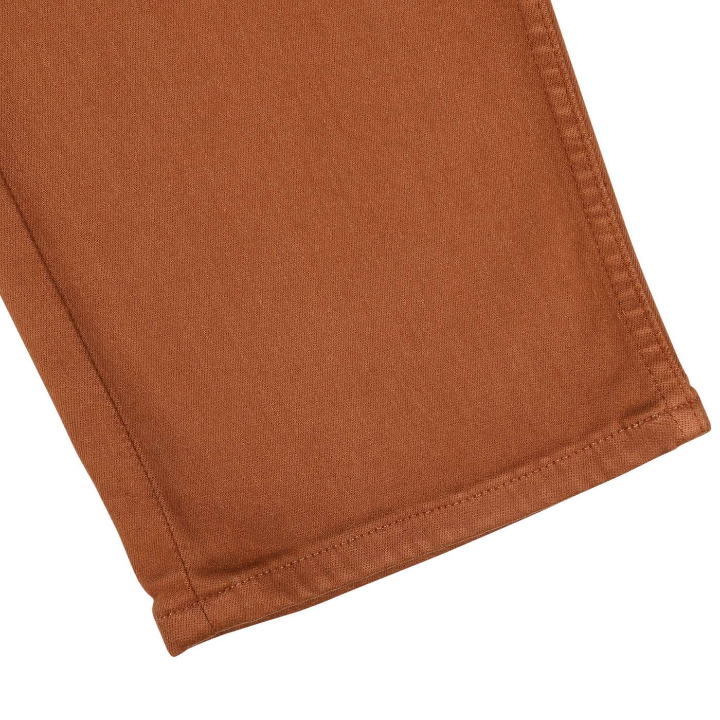 Close-up of the hem of Paige's Rust Brown Cotton Transcend Federal Slim Jeans. The stitching is visible along the bottom edge, showcasing a comfortable fit.