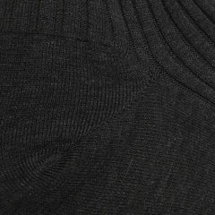 A close-up of Pantherella's Charcoal Egyptian Cotton Isle Danvers Ankle Socks reveals a ribbed fabric with visible texture and stitching, reminiscent of fine cotton lisle yarn.