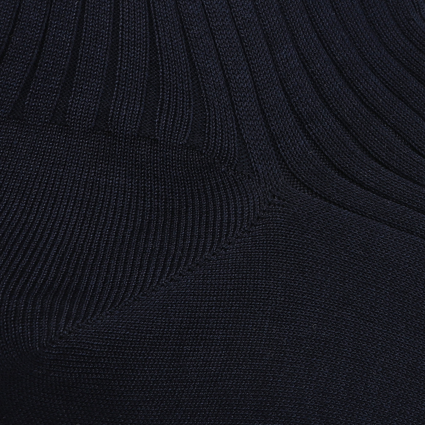 A close-up of Navy Egyptian Cotton Lisle Danvers Ankle Socks by Pantherella, highlighting black ribbed knit fabric crafted with delicate cotton lisle yarn, showing diagonal stitching and texture.