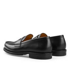 Black Leather Adonis Rubber Sole Loafers by Paraboot, featuring a stitched apron toe and low heel, are elegantly displayed at an angle on a white background.