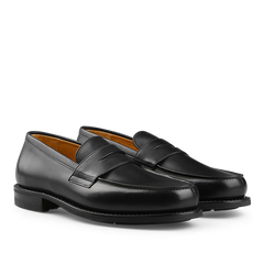 A pair of Paraboot Black Leather Adonis Loafers with a rounded toe and rubber sole is showcased on a white background.