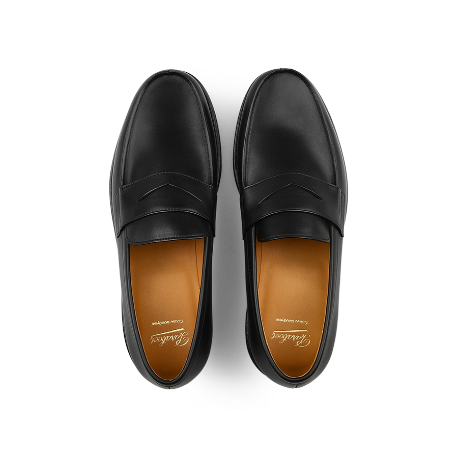 Paraboot's Black Leather Adonis Rubber Sole Loafers feature a rich brown inner lining and embody classic French loafer style, viewed from above.