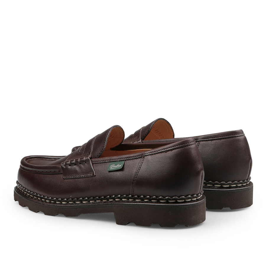 The Brown Lis Cafe Leather Reims Loafers by Paraboot, featuring a moc toe and rugged rubber soles with Norwegian-welt construction, are set against a plain white background.