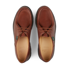 A pair of Brown Lis Marron Leather Michael Derbies by Paraboot isolated on a black background.