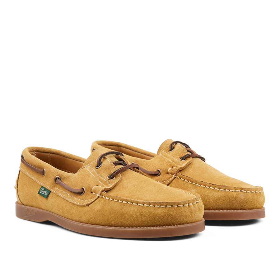 A pair of durable boat shoes in Light Beige Suede Leather Barth Moccasins by Paraboot with leather laces on a plain background.