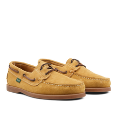 A pair of durable boat shoes in Light Beige Suede Leather Barth Moccasins by Paraboot with leather laces on a plain background.