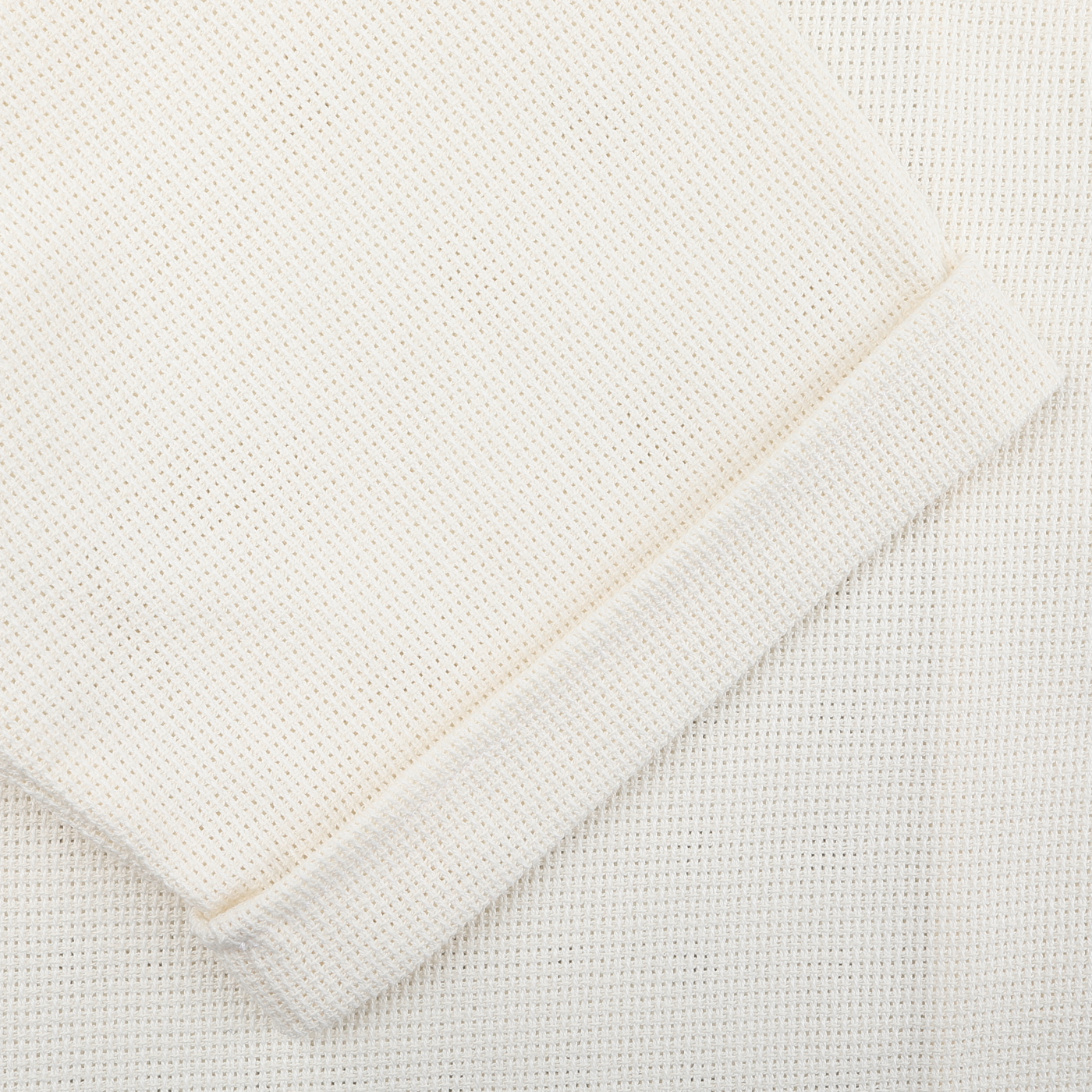 Close-up of the textured fabric with a rolled edge, as seen in Peregrine's Cream Dry Cotton Cuban Collar Shirt.