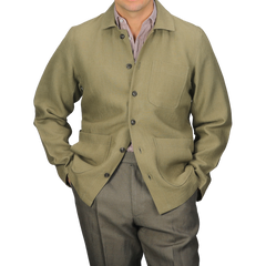 A person wears the Peregrine Khaki Green Linen Grange Shacket over a collared shirt and matching pants, with hands casually tucked in pockets.