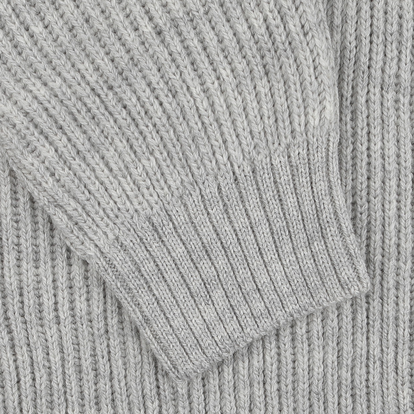 Close-up of a Light Grey Wool Ford Zip Neck Sweater sleeve by Peregrine, showcasing the elegance of premium British knitwear.