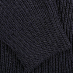 Close-up of a dark-colored, ribbed knit fabric from a Navy Blue Wool Ford Raglan Crewneck by Peregrine, showing detailed texture and pattern.