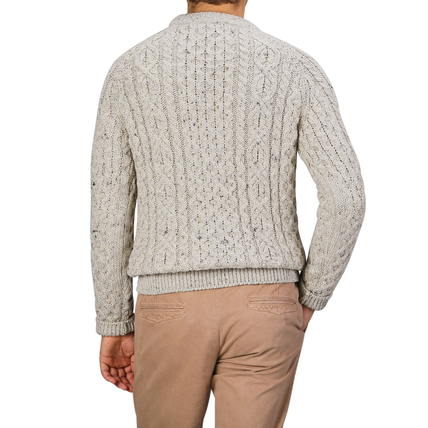 A person wearing a Peregrine Skiddaw Beige Merino Wool Hudson Aran Jumper and tan pants, viewed from the back against a plain gray background.