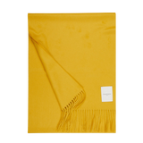 A Mustard Yellow Cashmere Aeternum Scarf with fringed endings on a white background.