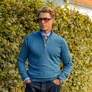 A man wearing a Piacenza Cashmere Blue Melange Cashmere 1/4 Zip Sweater.
