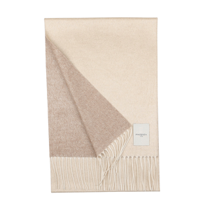 A Cream Hazelnut Two-Sided Silk Cashmere Scarf from Piacenza Cashmere, featuring fringed endings, is neatly folded with a visible label on one corner.