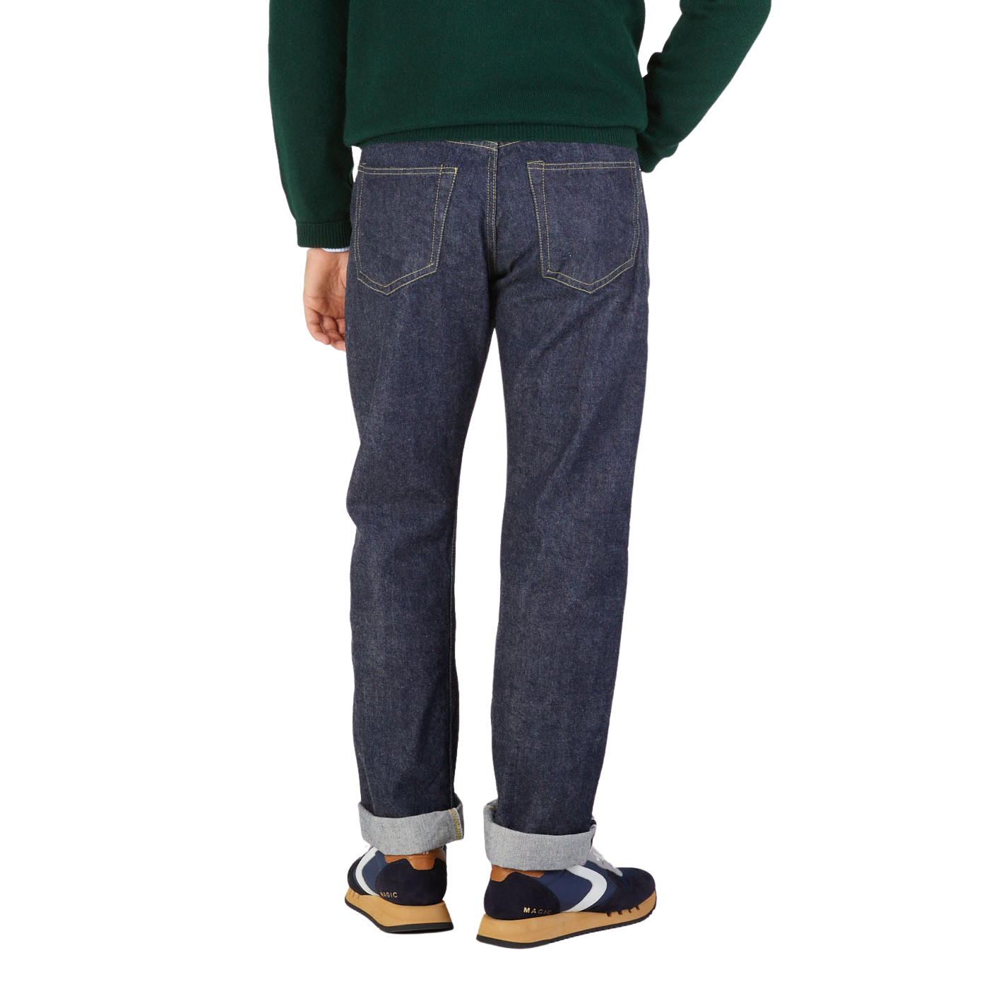 Rear view of a person wearing Resolute's Dark Blue Cotton 714 One Wash Jeans and multicolored sneakers, with a green sweater tucked in.