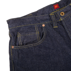 Close-up of dark blue cotton Resolute 714 One Wash jeans featuring detailed stitching and a front pocket with a visible red brand tag.