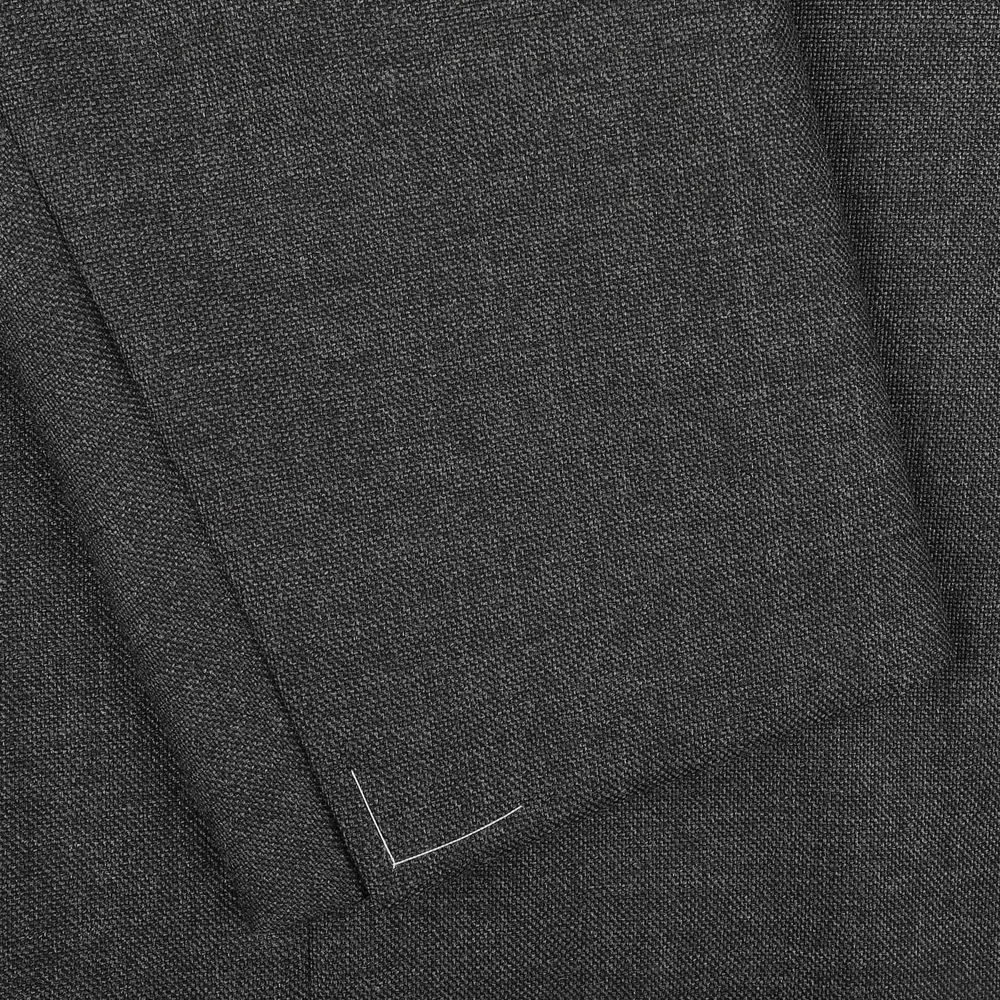 Close-up of the Grey Calm Twist Wool DB Suit by Ring Jacket, featuring textured grey fabric with overlapping edges and fine white stitch detailing that showcases the elegance of wool.