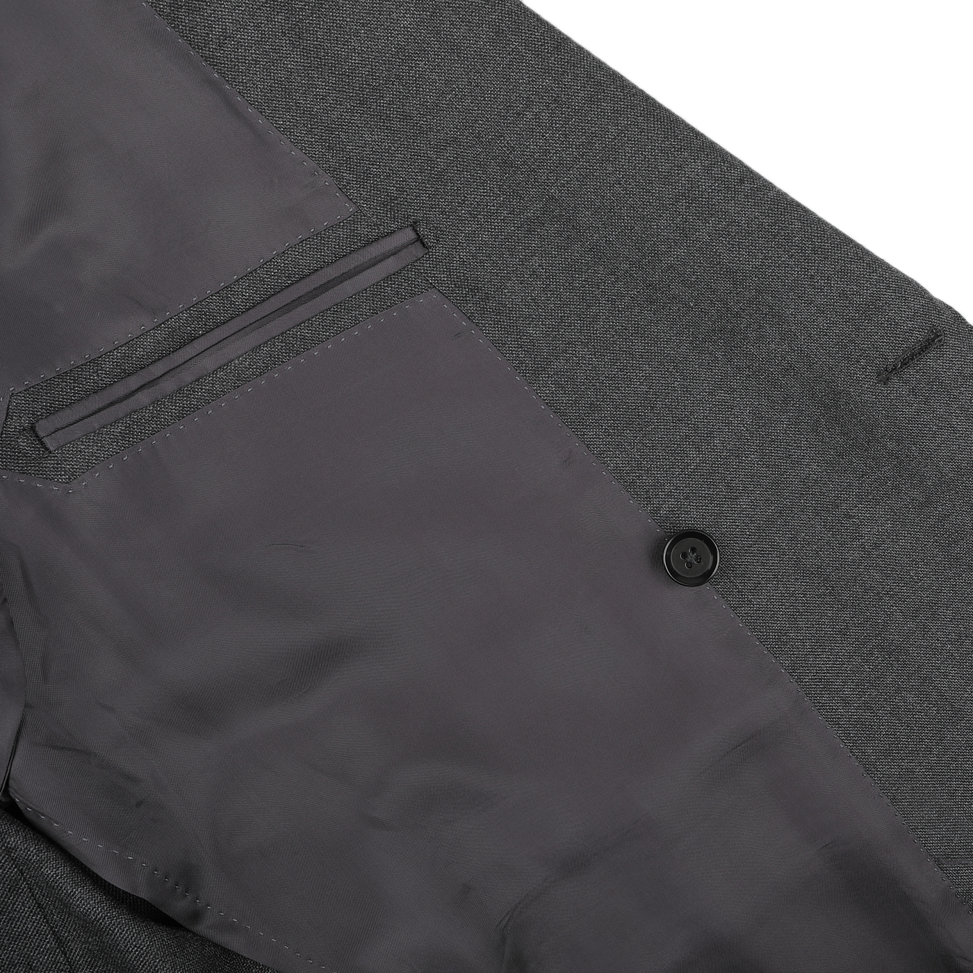 Close-up of the Grey Calm Twist Wool DB Suit from Ring Jacket, featuring a fine wool fabric with a black button and a lined pocket.