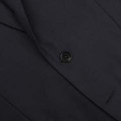 Close-up of the Navy Blue Calm Twist Wool Suit by Ring Jacket, showcasing a suit jacket made from high-twist wool fabric with a single black button and visible stitching detail.