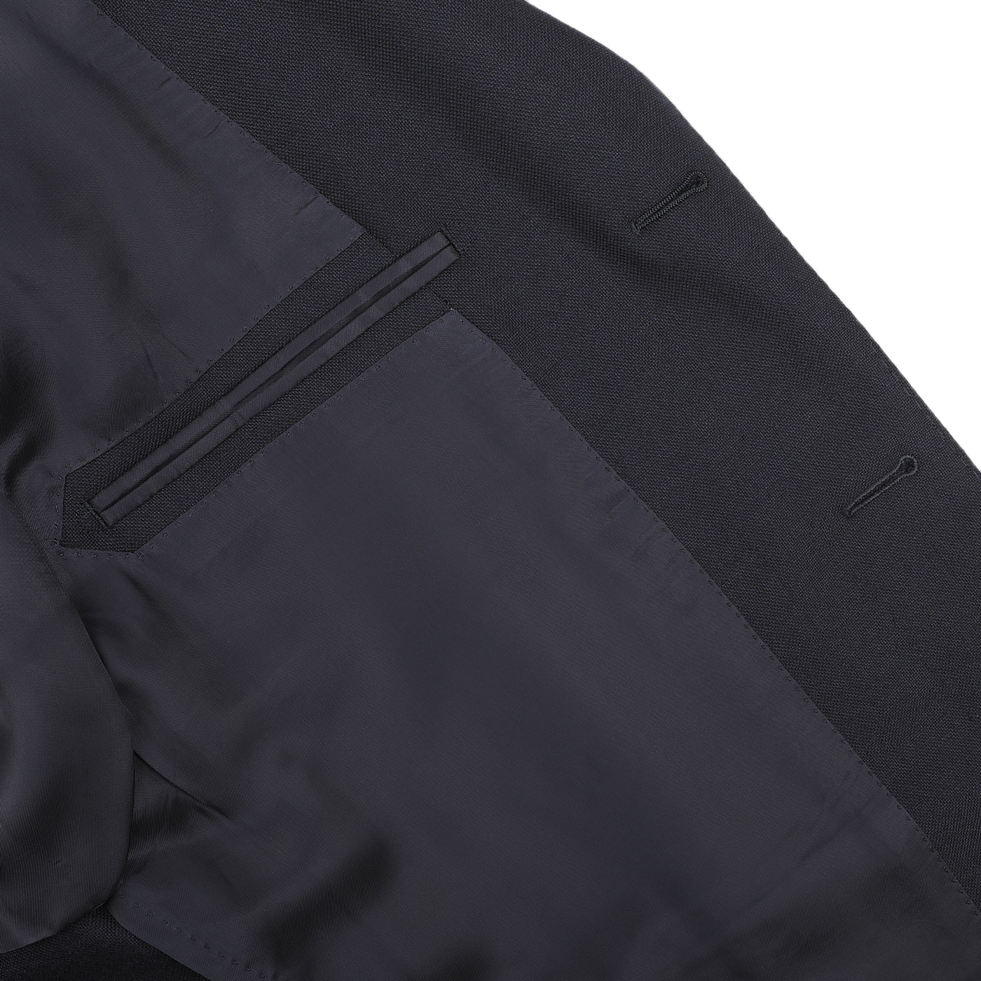 Close-up of an inside view of a Navy Blue Calm Twist Wool Suit blazer with a visible pocket and buttonhole stitches on the lining, crafted by Ring Jacket from high-twist wool fabric.