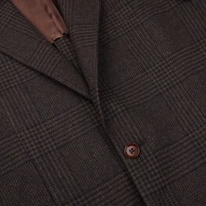 A close up of a Brown Black Prince of Wales Wool Balloon Blazer with brown buttons by Ring Jacket.