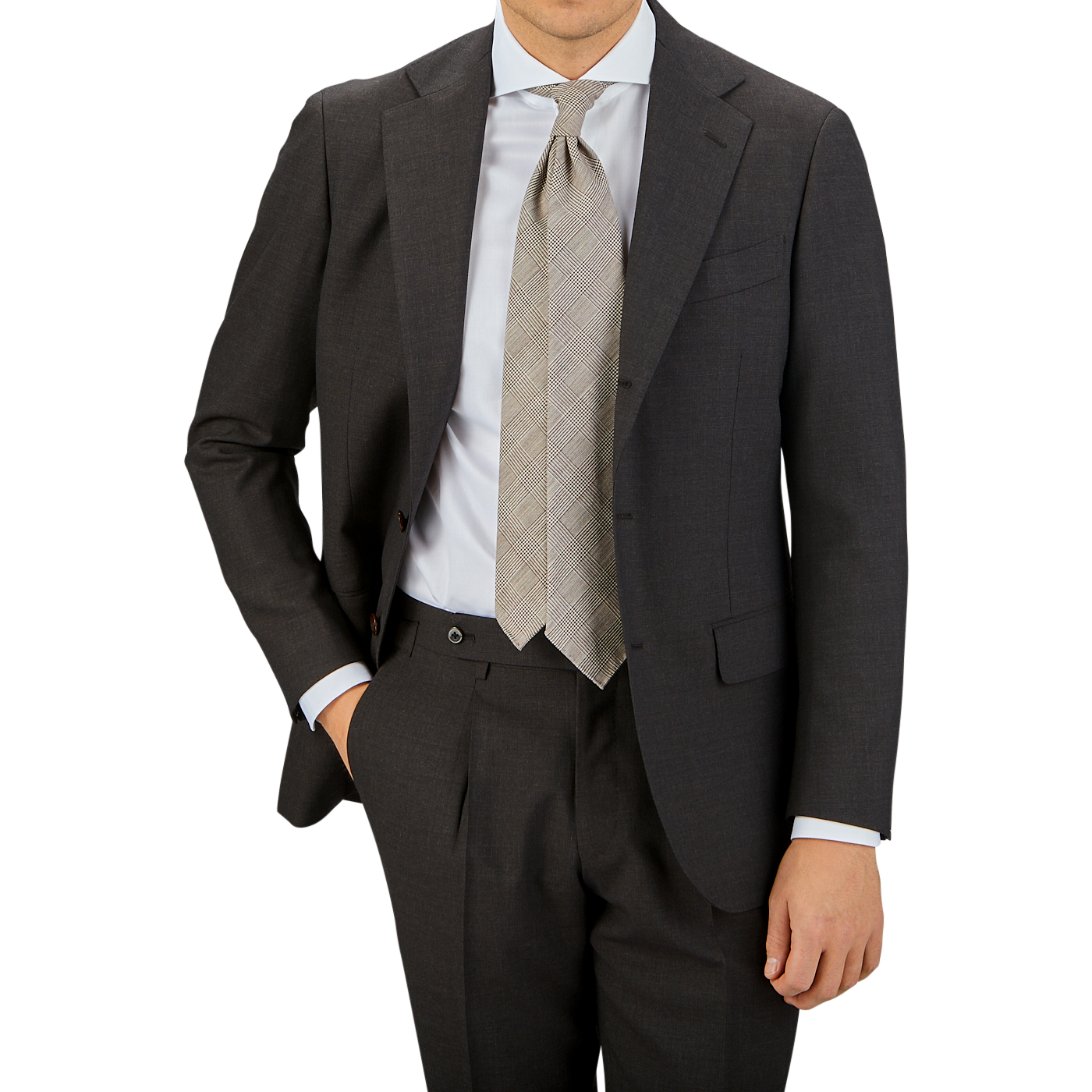 A man in a Ring Jacket dark brown high twist wool suit with a white shirt and plaid tie stands against a neutral background, cropped at the chest.