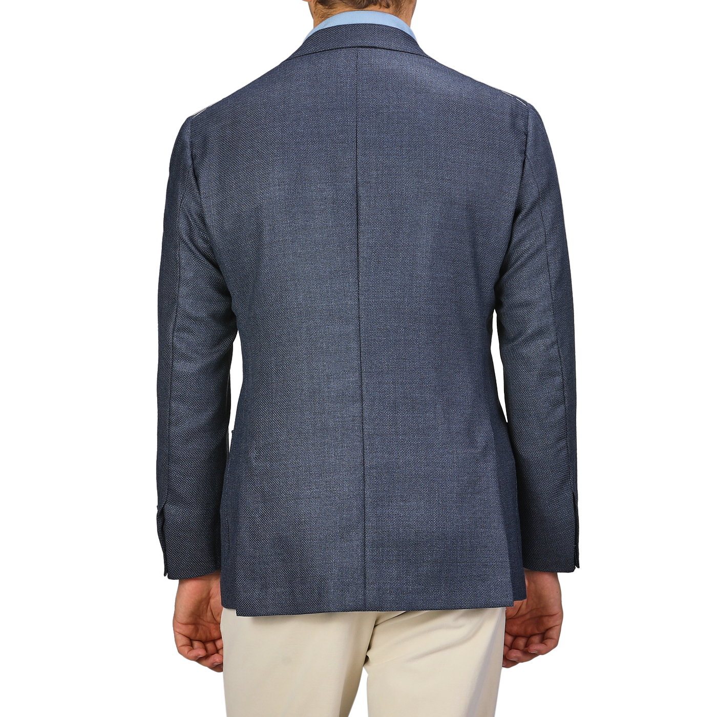 A person is shown from the back, wearing a Denim Blue Wool Balloon Travel Blazer by Ring Jacket in an elegant blazer style with beige pants.