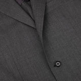 Close-up of a Ring Jacket Dark Grey High Twist Wool Suit showing detail of wool fresco fabric texture, lapel, and a black button.