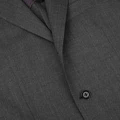 Close-up of a Ring Jacket Dark Grey High Twist Wool Suit showing detail of wool fresco fabric texture, lapel, and a black button.