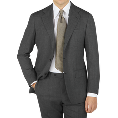 A contemporary version of a man wearing a Ring Jacket Grey High Twist Wool Suit, complete with a tie.