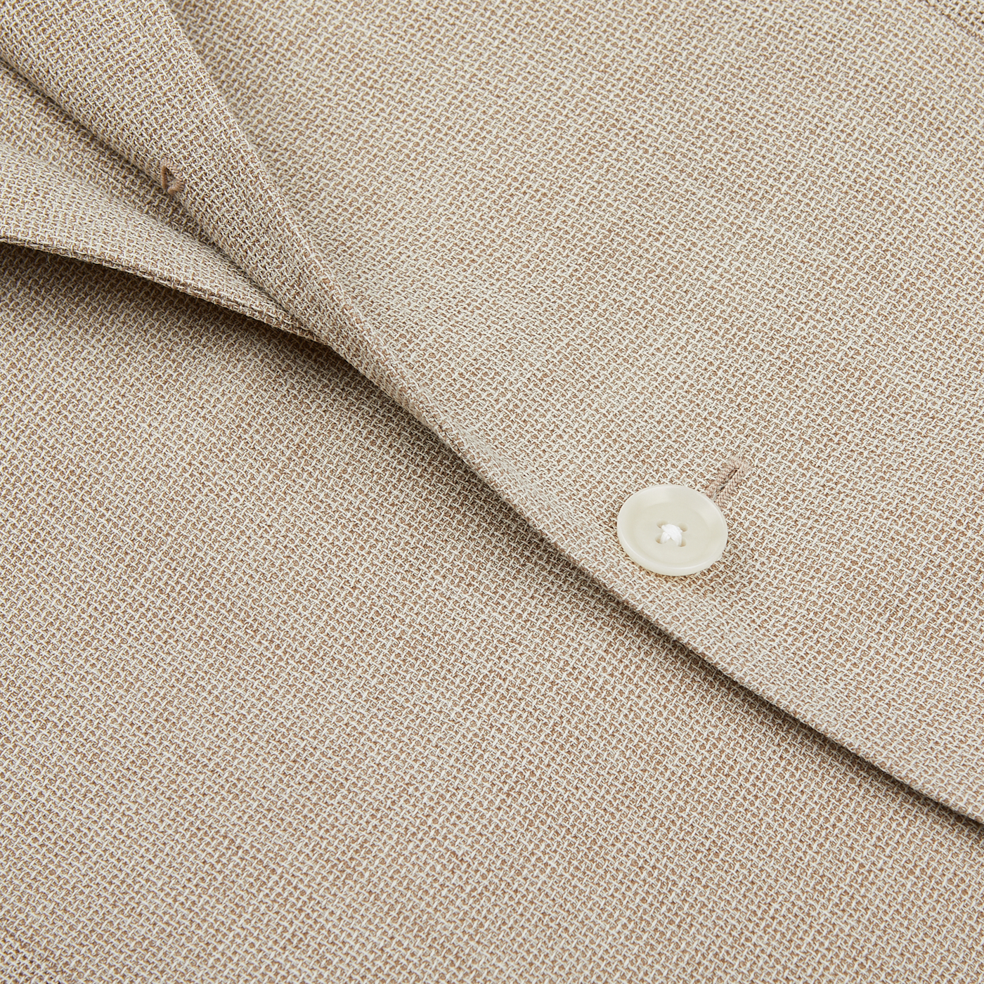 Close-up of a Ring Jacket Light Beige Wool Balloon Travel Blazer showing detailed texture with a focus on the collar and a button.
