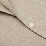 Close-up of a Ring Jacket Light Beige Wool Balloon Travel Blazer showing detailed texture with a focus on the collar and a button.