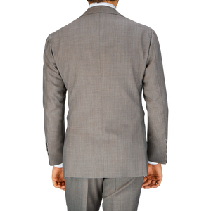 A man viewed from behind wearing a Mid Grey High-Twist Wool Ring Jacket suit jacket and pants.