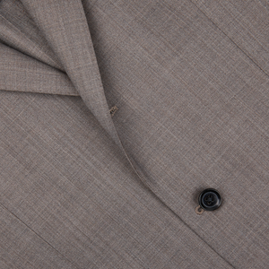 Close-up of a textured Ring Jacket wool fabric with a button, likely part of a garment such as a Ring Jacket suit.