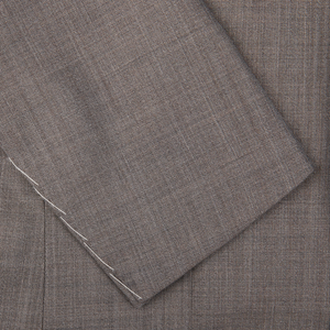 Close-up of a Mid Grey High-Twist Wool Ring Jacket suit fabric with a herringbone pattern.