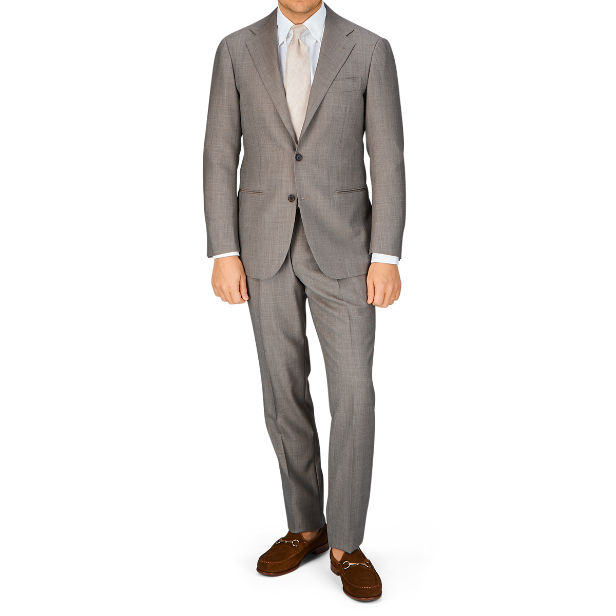 Man standing in a Ring Jacket Mid Grey High-Twist Wool suit with a light shirt and brown shoes.