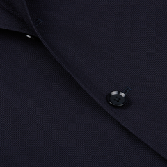 Close-up of a Ring Jacket Navy Blue Wool Balloon Travel Blazer featuring a detailed view of a button and fabric texture.