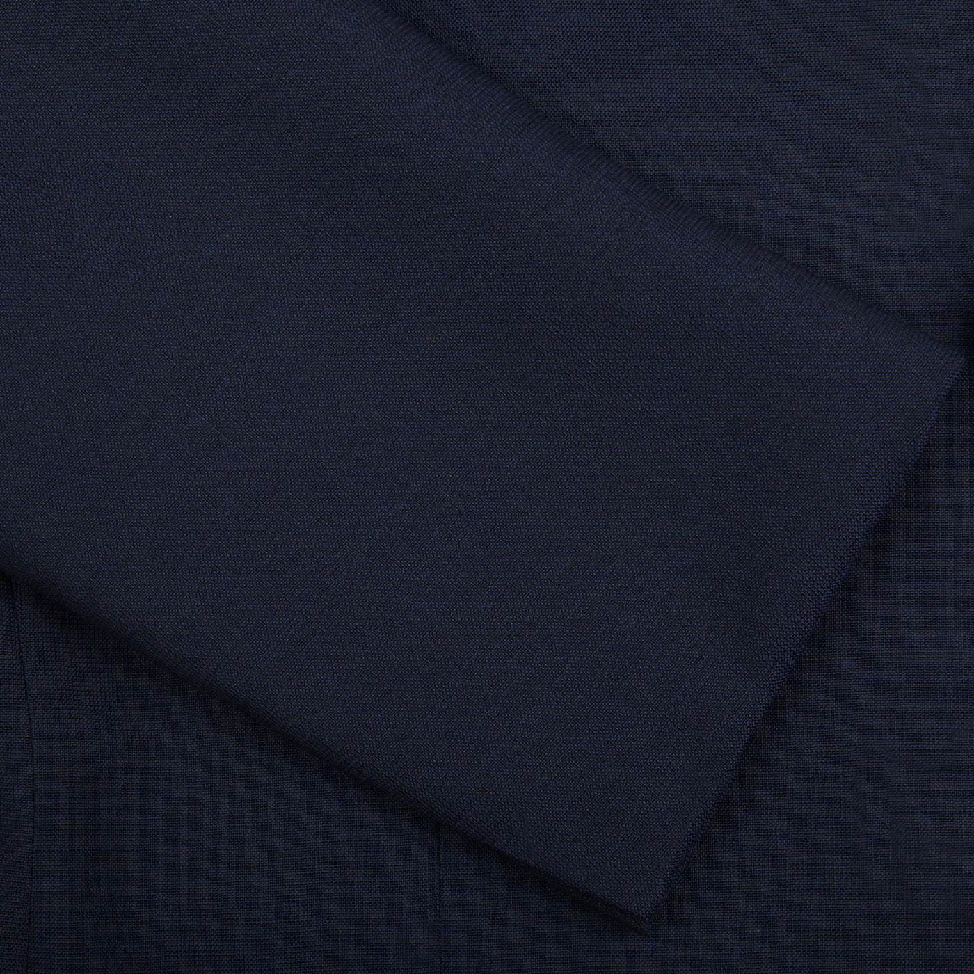 A close up of a Ring Jacket Navy High Twist Wool Suit made with fresco fabric.
