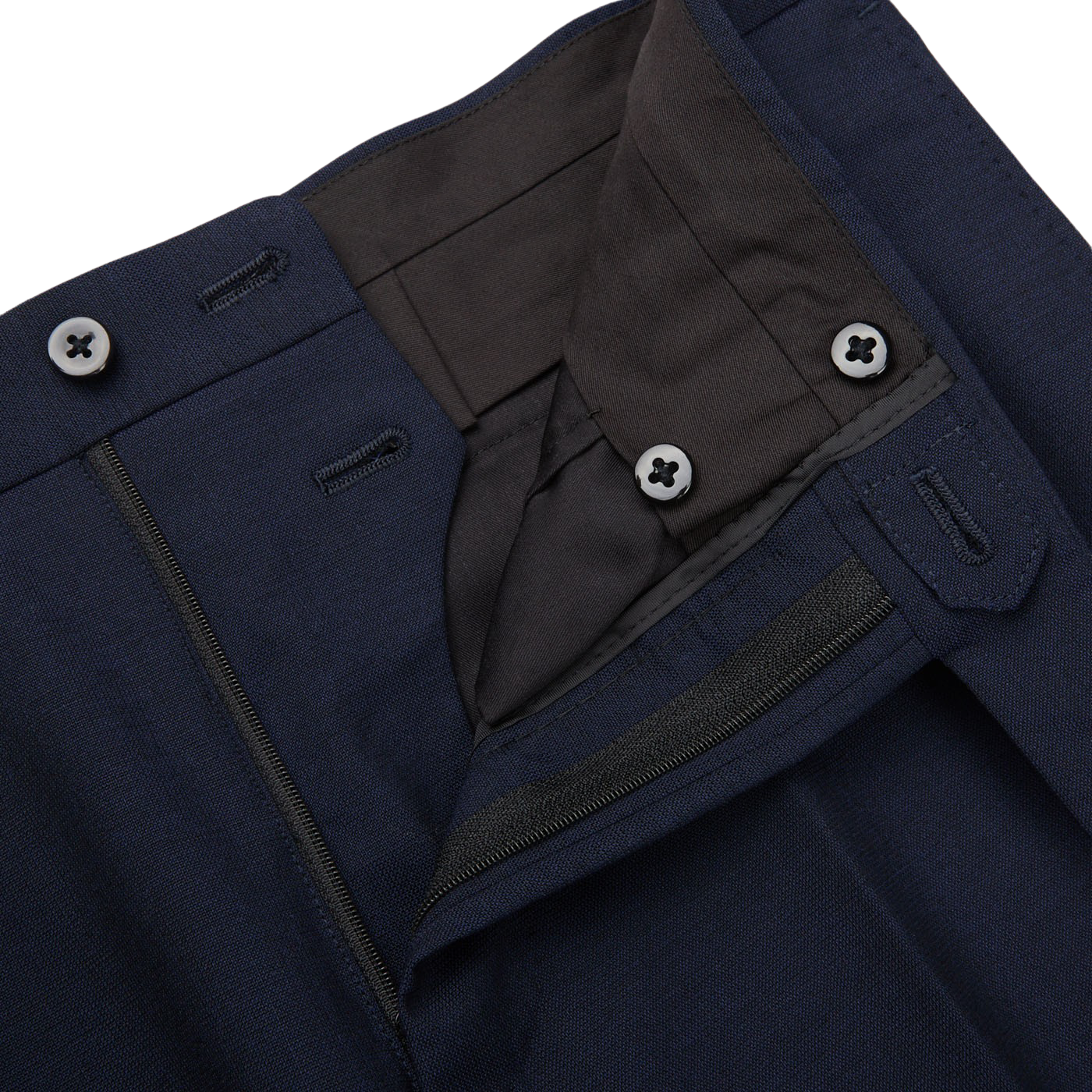 Close-up of a Ring Jacket navy blue high twist wool suit, showing the buttoned waistband and zipper, with detailed stitching and fabric texture visible.